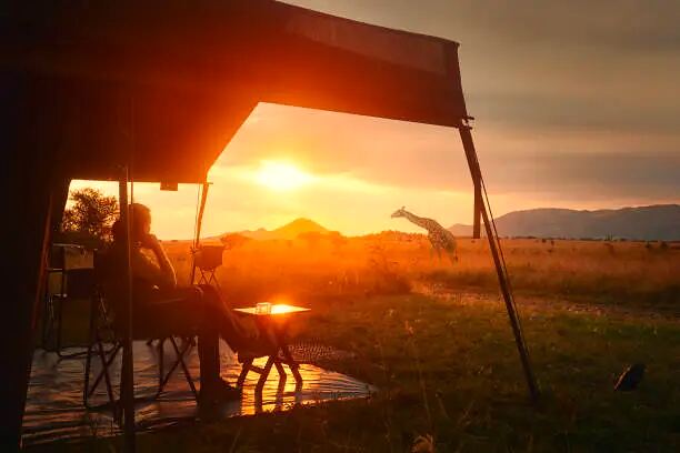 Luxury tented suite with a view onto the Tanzanian plains at sunset